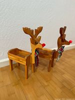 Front three-quarter view of both wooden reindeer planters