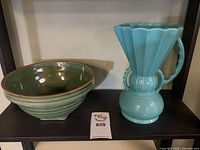 Green bowl and turquoise pitcher on shelf
