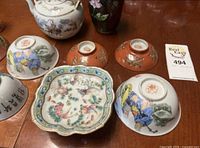 Overview of bowls, scalloped fish dish, teapot, cloisonné vase