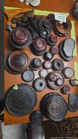 Tabletop view showing majority of round dark-stained wooden stands in various sizes