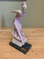 Front view of porcelain flapper dancer figurine on marble base