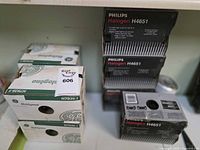 Stack of Philips H4651 headlight boxes visible on right side