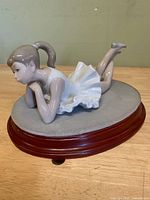 Overall view of ballerina figurine on wood base