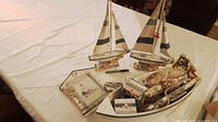 Overview of sailboats, boat bowl and contents on table
