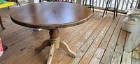 Full view of round pine table on deck