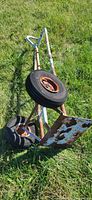 Hand truck lying on grass showing wheels and loading plate