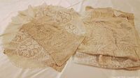 assortment of lace pieces laid out, round and rectangular