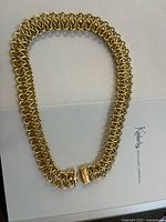 Full view of gold interlocking link necklace laid flat