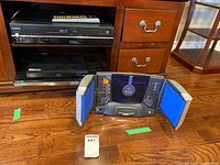 Front view showing Toshiba DVD/VHS combo with remote, LG or Samsung Blu-ray player beneath, and ULTech CD player opened