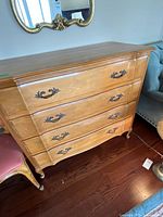 Front view of dresser showing four drawers and hardware