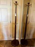 Full view of hall tree showing entire height, top hooks, and base