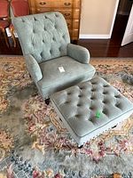 Armchair and ottoman together showing upholstery color and style