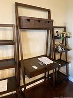 Front view of leaning desk shelf showing drawers and work surface