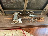 Overhead view showing cannon attached to limber wagon and separate brass cannon
