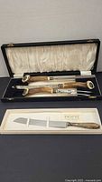 Overall view of carving set and cake knife in boxes
