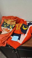 All three folded flags showing assorted shields and colours