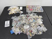 Entire lot with piles of bagged jewelry and organizer