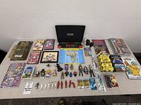 Overhead of full assortment showing GeoSafari console, books, binder, figures, media