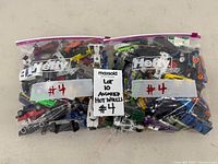 Two bags filled with assorted die-cast toy cars