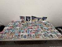 Wide shot of entire table showing large quantity of sleeved trading cards