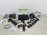 Full lot overview showing DVR, 4 cameras, 4 receivers, power adapters, remote, mouse, cables, manuals and software