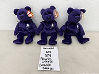 Three purple Princess Diana Ty Beanie Baby bears with lot card