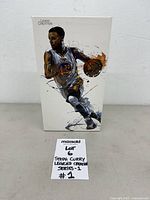 Front of boxed Stephen Curry figure with lot card