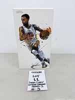 Front view of boxed Steph Curry figure showing artwork and lot tag