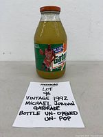 Front view of sealed Michael Jordan Gatorade bottle with MaxSold note