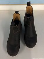 Top view of both Aquatherm ankle boots showing overall shape, toe wear, and pull tabs