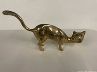 Full side view of brass cat figurine