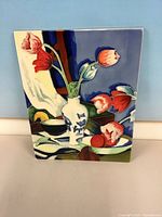 Front view showing entire ceramic wall hanging with decorative still-life design