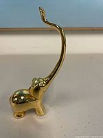 Front side of gold-tone elephant ring holder showing full trunk