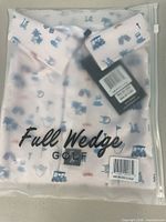 Front of sealed bag showing Full Wedge branding and folded polo