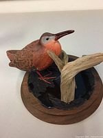 Front view of carved bird on base