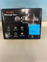 Front of sealed Taijima Massage Gun box with feature list
