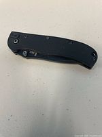 Knife folded showing black textured handle