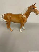 Full side view of brown and white porcelain horse figurine