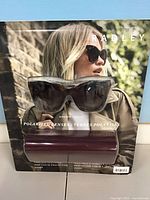 Front view of packaged Radley sunglasses and case showing branding and polarized lens label