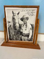 Overall view of framed Roy Rogers photograph on tabletop