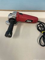 Overall view of Skil angle grinder showing body, side handle, and cord