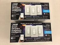 Front view of two sealed 3-pack Feit Electric Smart Dimmer boxes