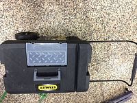 Top view of Stanley rolling tool chest with handle, clear organizer lid, and branding