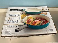 Front of sealed box showing both skillets, brand and size info