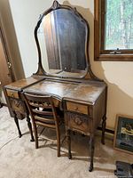Full view of vanity with mirror and chair