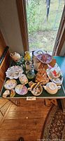 Overall view of table holding assorted china, glass and ceramic items