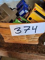 Basket filled with assorted toy vehicles showing variety and wear