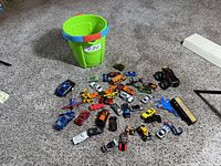 wide view of entire lot on carpet with green bucket