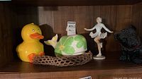 All four decorative items on shelf