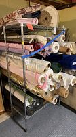 Wire shelving unit holding fabric rolls (contents excluded) showing construction and shelf count